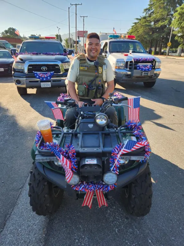 A member riding a decorated ATV in a Fourth of July parade